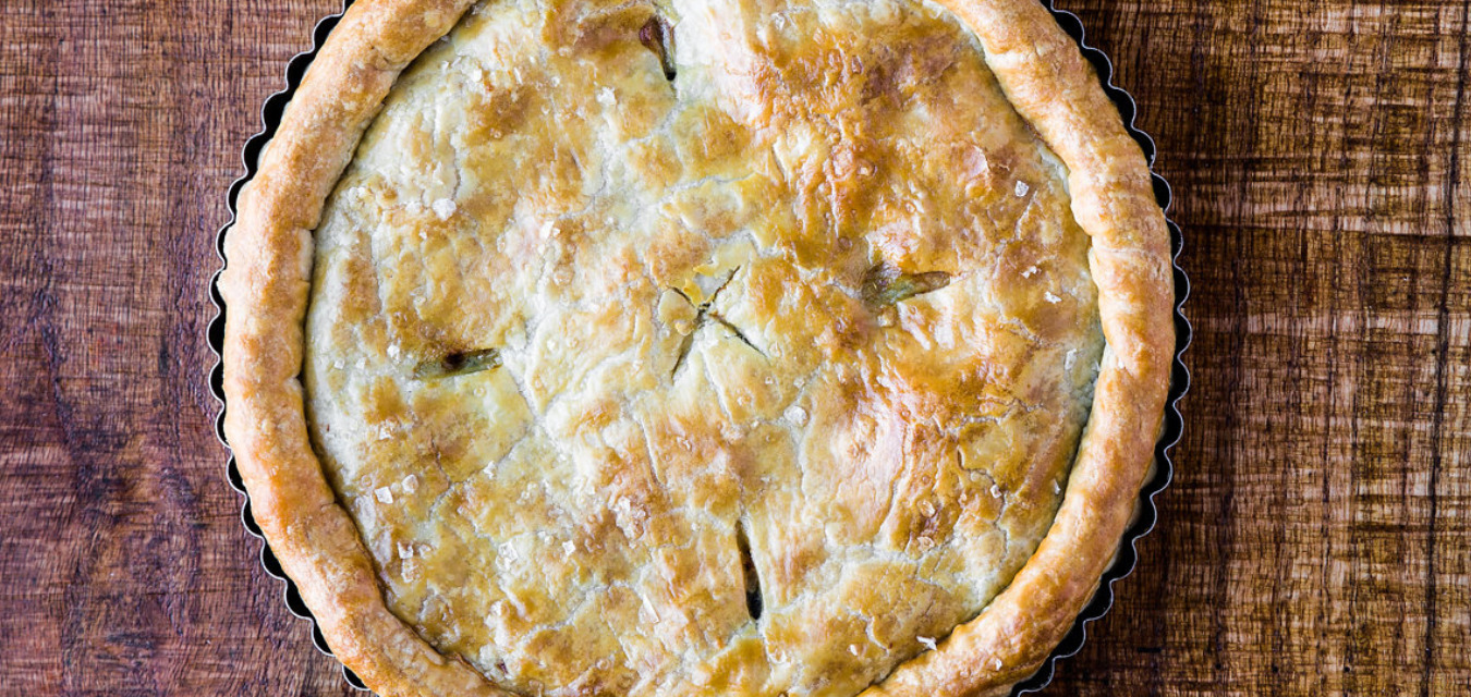pot pie: image of a turkey pot pie with a golden brown crust on a wooden table