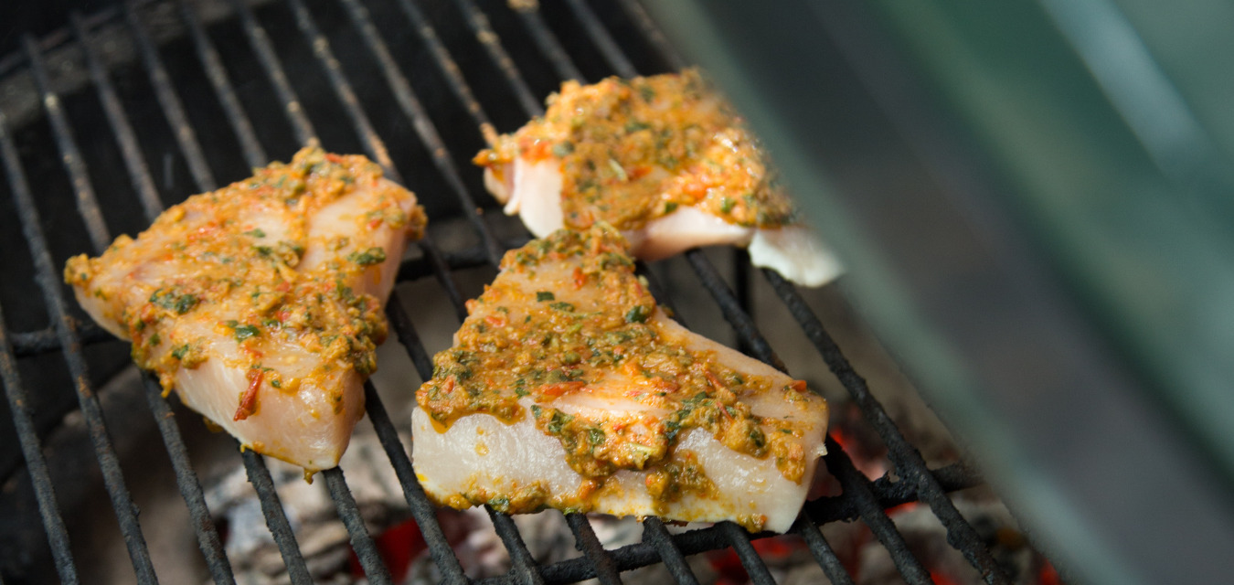pieces of swordfish cooking on the grill