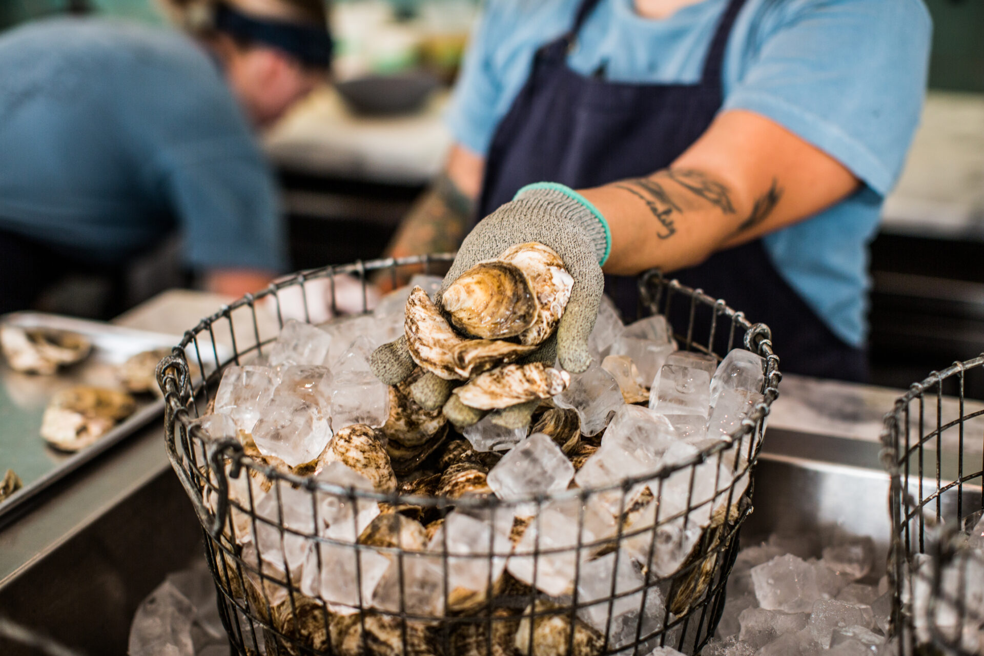 Fresh oysters being shucked at Henrietta Red's, a music city chef jam participating restaurant in Nashville, Tennessee.