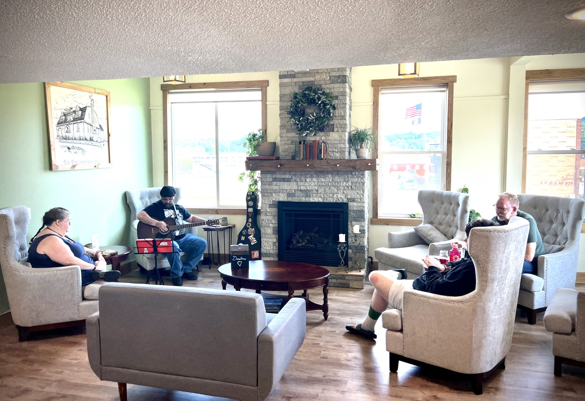 Customers and arts enthusiasts alike gather for classes in chairs around the fireplace at the the Philosopher's House.