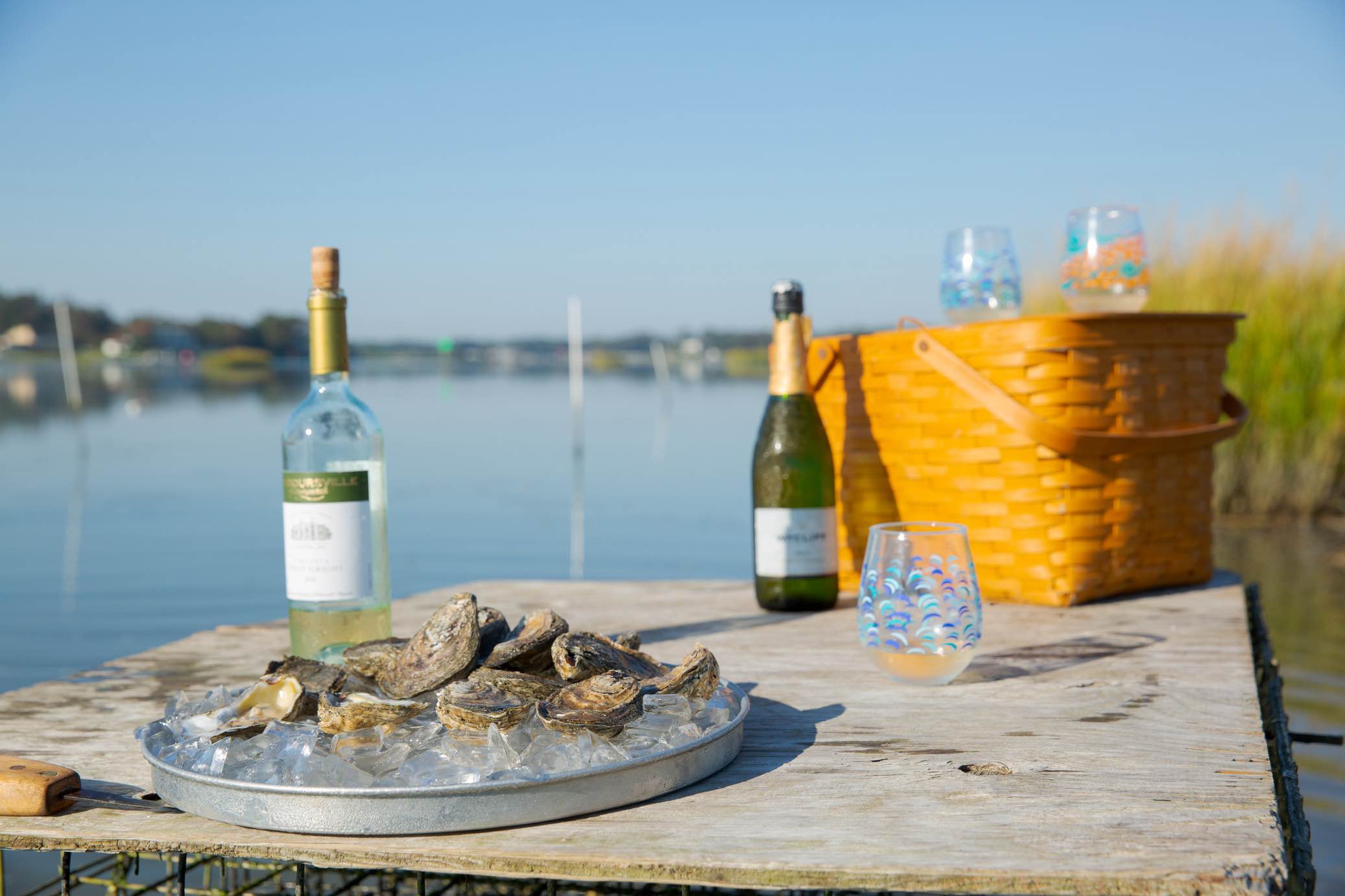 A plate of Lynnhaven oysters with white wine served by the water