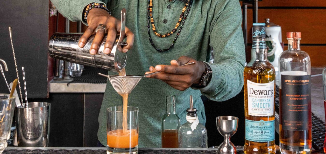 Worship Chaleka mixing a cocktail