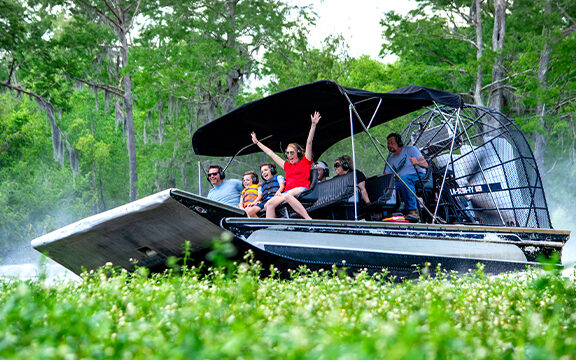 Family on a boat during summertime In Lafayette, Louisiana