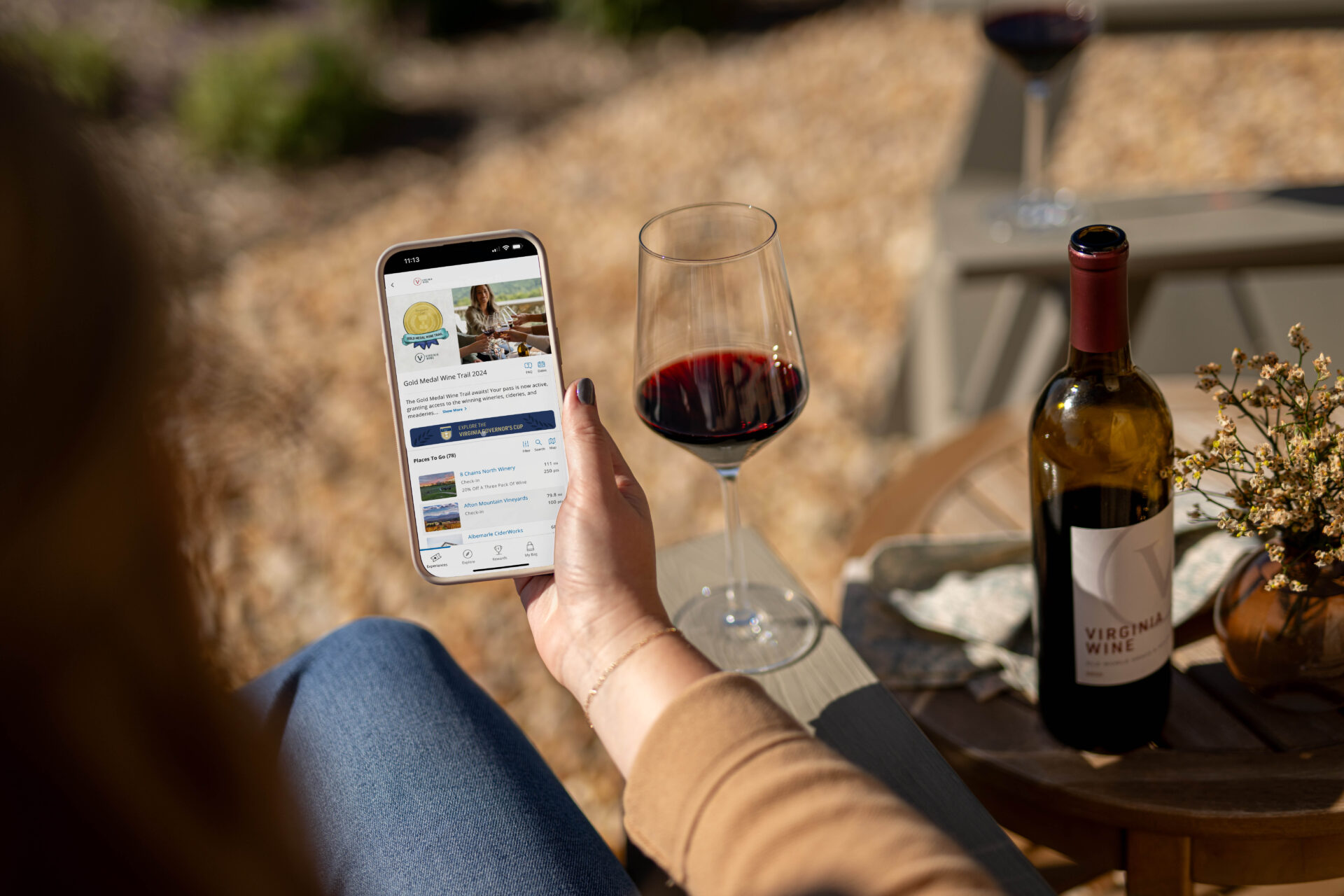 A women using the app for the Gold Medal Wine Trail.