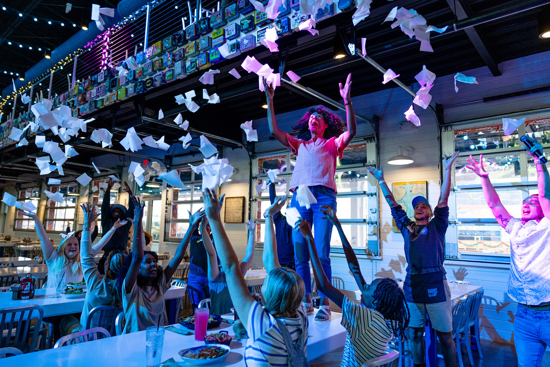 People throwing napkins in the air in celebration at a restaurant in Myrtle Beach, South Carolina.