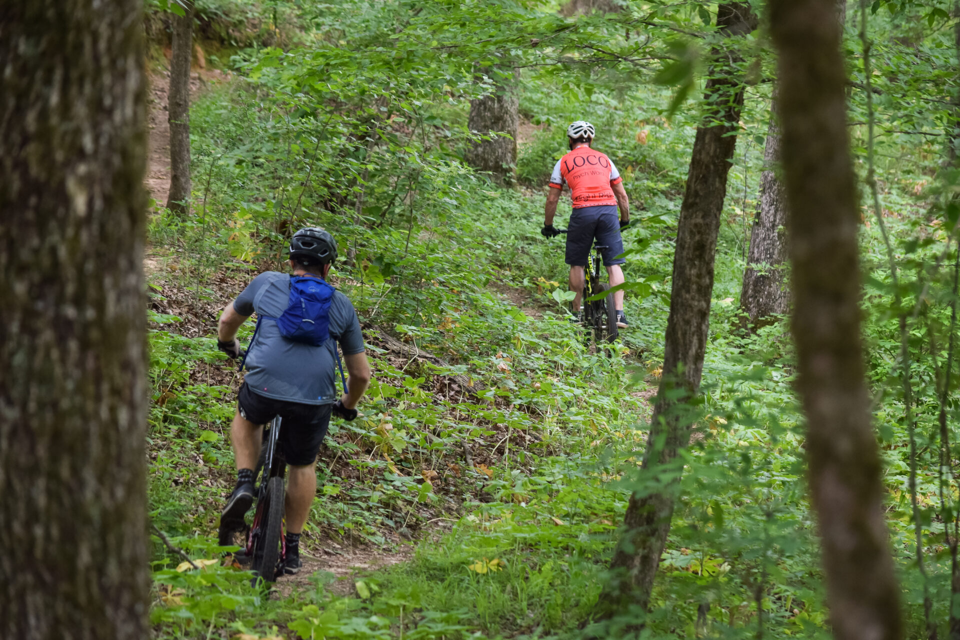 Two mountain bikers riding an intense route through the Lincoln Parish Park forest in Ruston, Louisiana. 