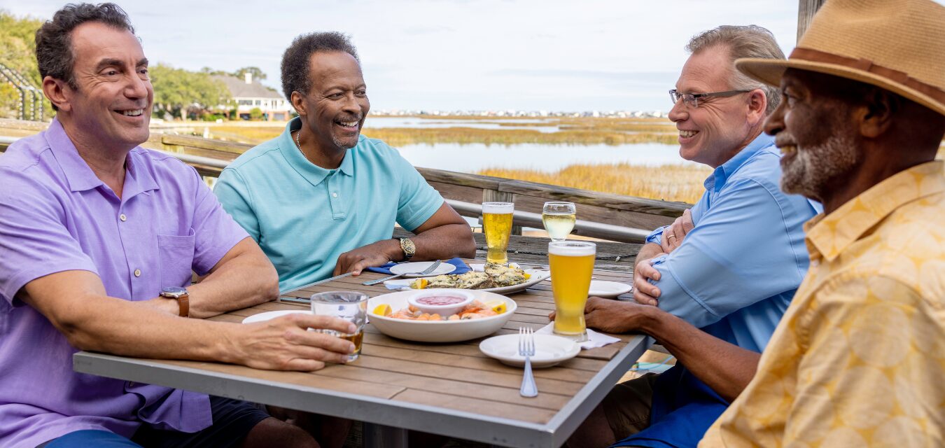 Three men enjoying beers on a patio in Myrtle Beach, South Carolina.