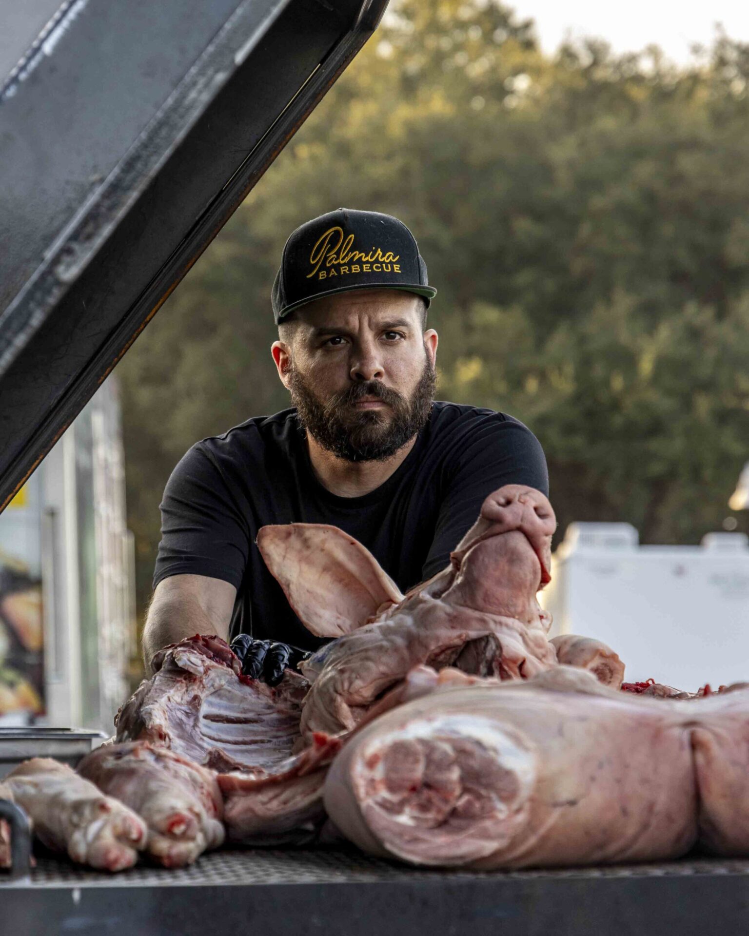 Chef Hector Garate of Palmira Barbecue poses on his grill. 