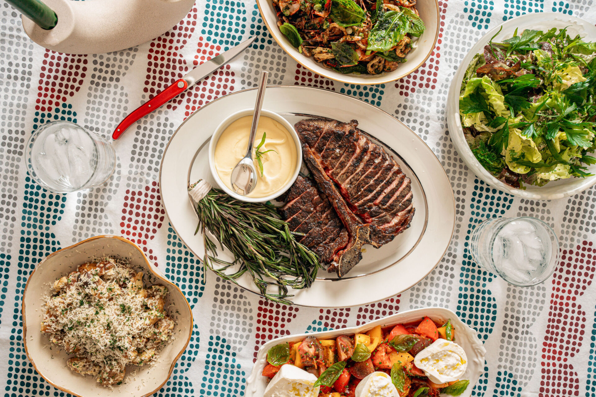 Joe Cash's Father's Day feast featuring steak, shrimp, salad, and potaotes