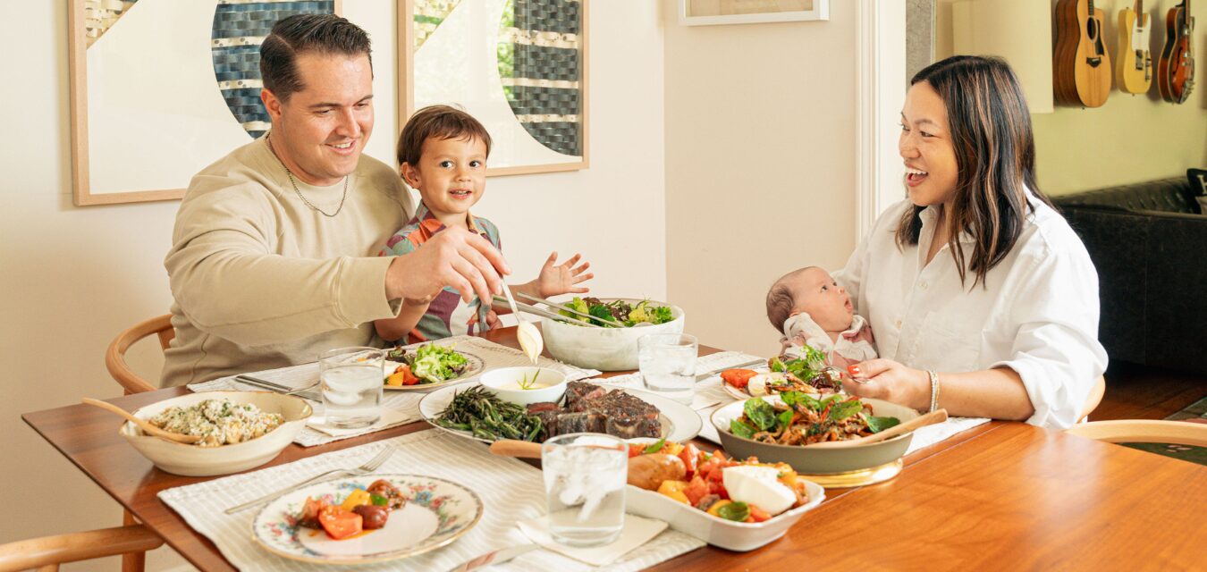 a family shares a feast with a Mixed green salad w/ blue cheese and fine herbs