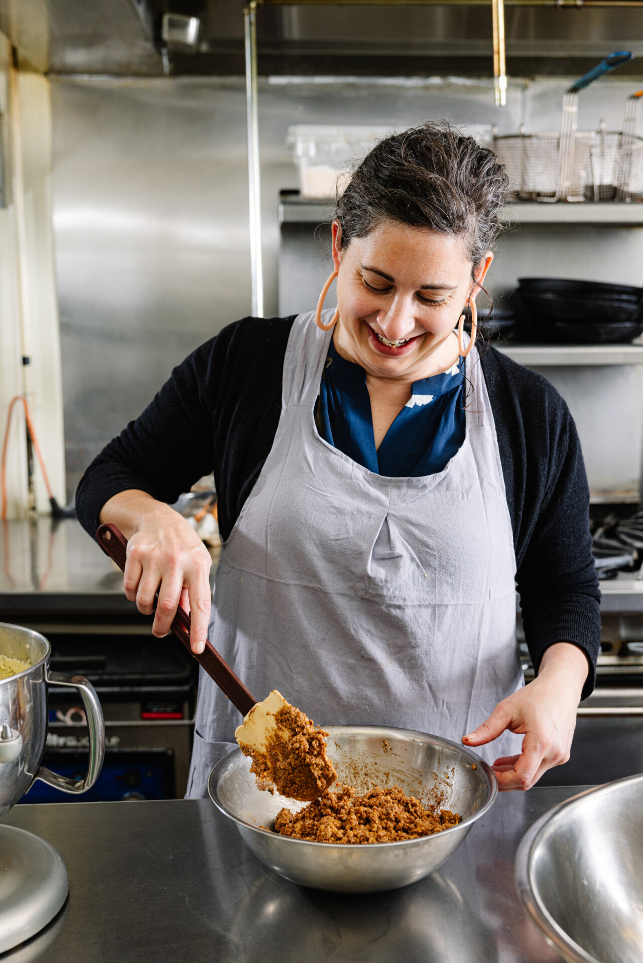 Eleanor Lacy stirs the crushed praline crunch into the rice krispie and chocolate ganache mixture.