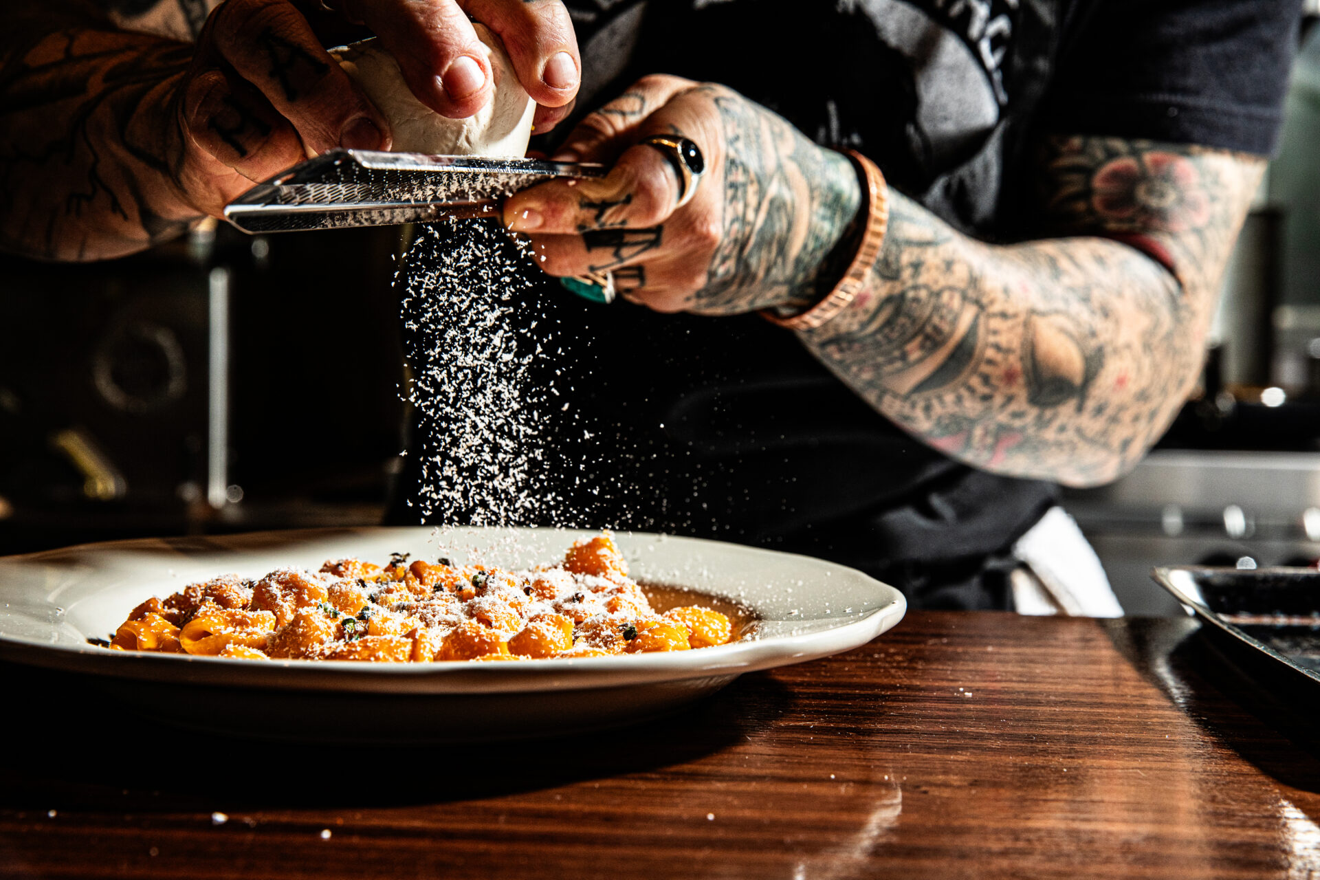 parmesan shaved over a plate of pasta 