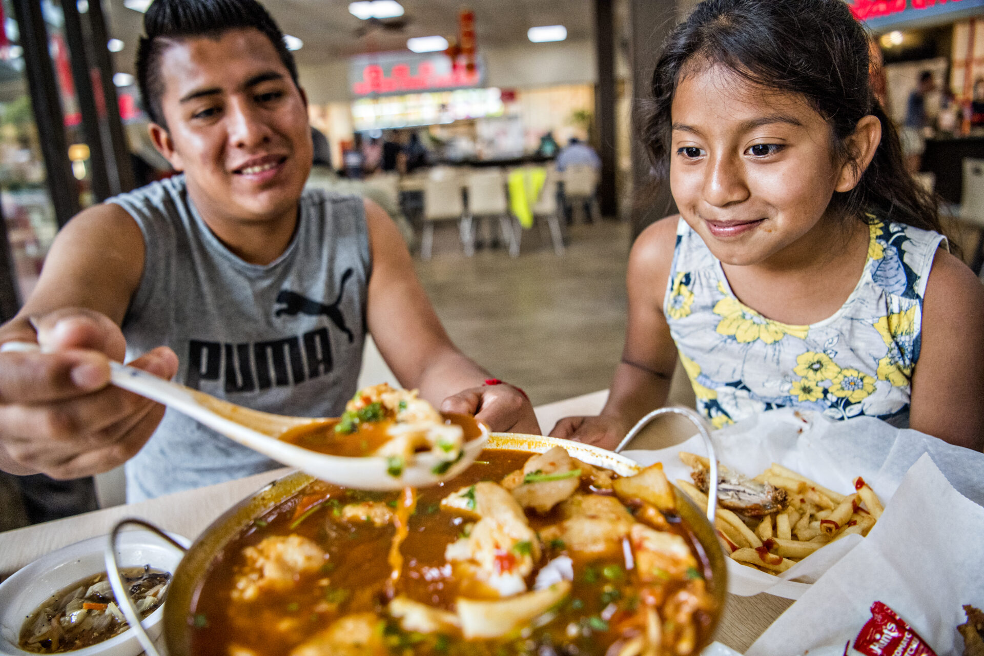 Two people eating at Chinatown Mall in Chamblee, Georgia.