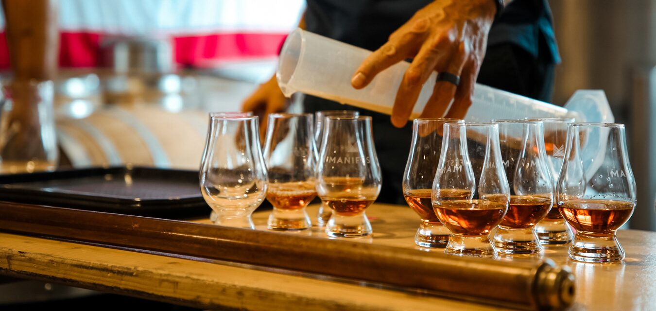 Featured image of gin samples being poured at Manifest Distillery