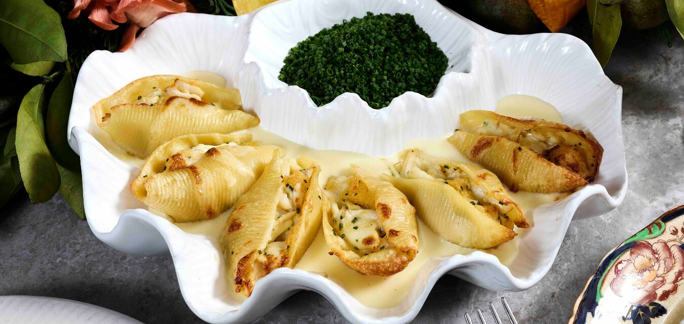 stuffed crab shells with a bowl of chives