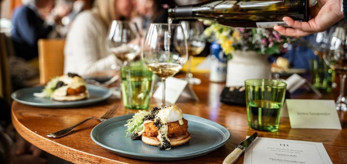 A glass of win being poured at a table at the High Hampton in Jackson County, North Carolina.