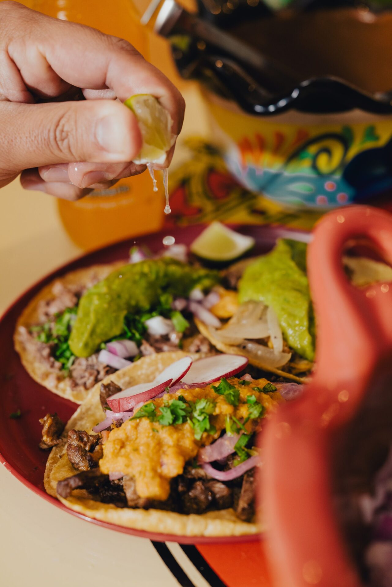 Customer squeezing lime over tacos from Salud Taqueria in Birmingham, Alabama