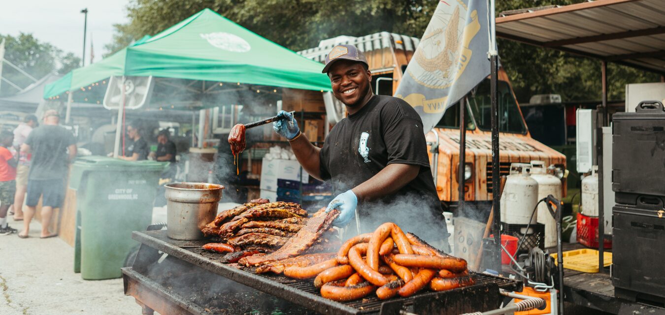 A man preparing a variety of meats for the Festival of Discovery BBQ in South Carolina's Old 96 District