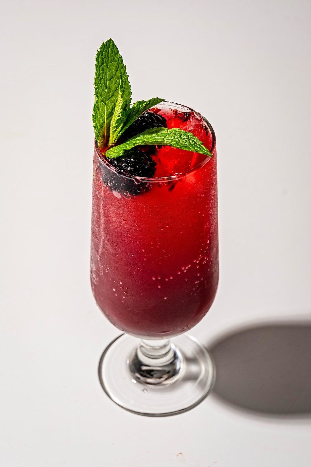 A brightly colored mocktail with blackberry and mint from binge bar, a featured dry bar