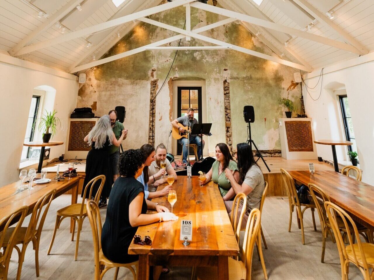 A group of friends and a couple, dancing, drinking, and listening to live music at Potter's Craft Cider in Charlottesville and Albemarle County, Virginia.