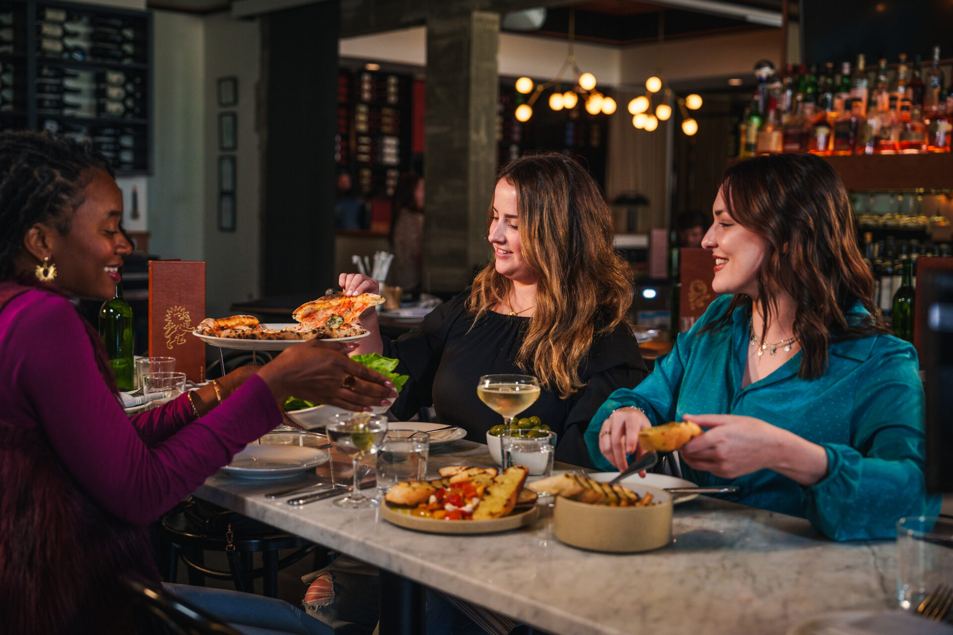 Women dining and enjoying drinks at Saint Leo in Oxford.
