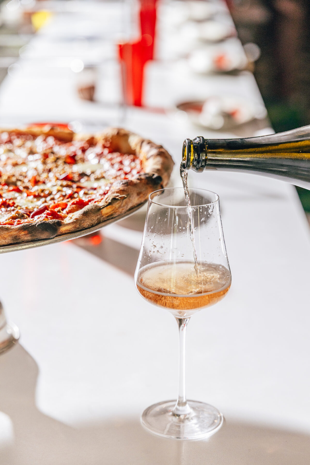 A glass of wine with pizza