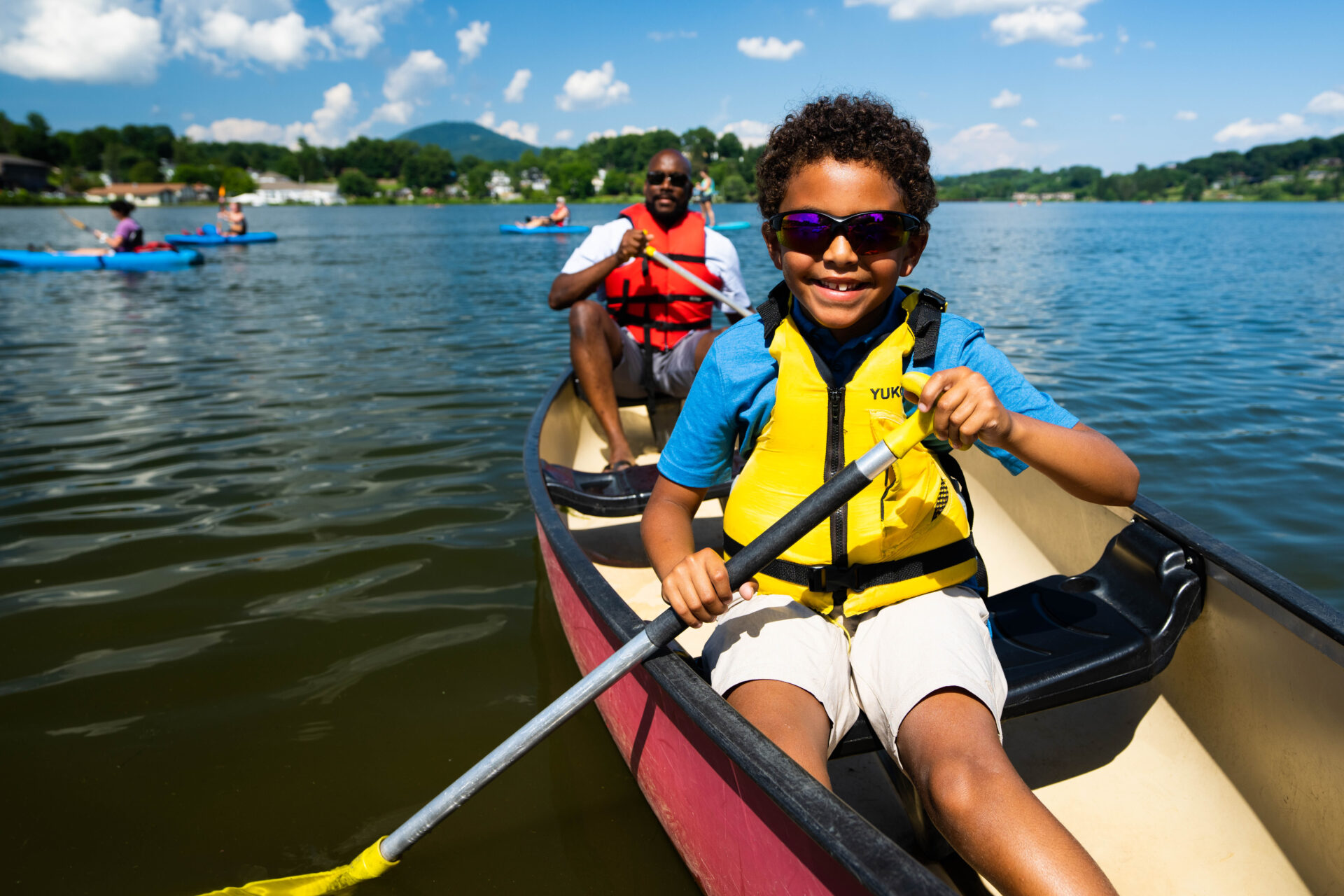 A man and his son canoeing at Lake Junaluska