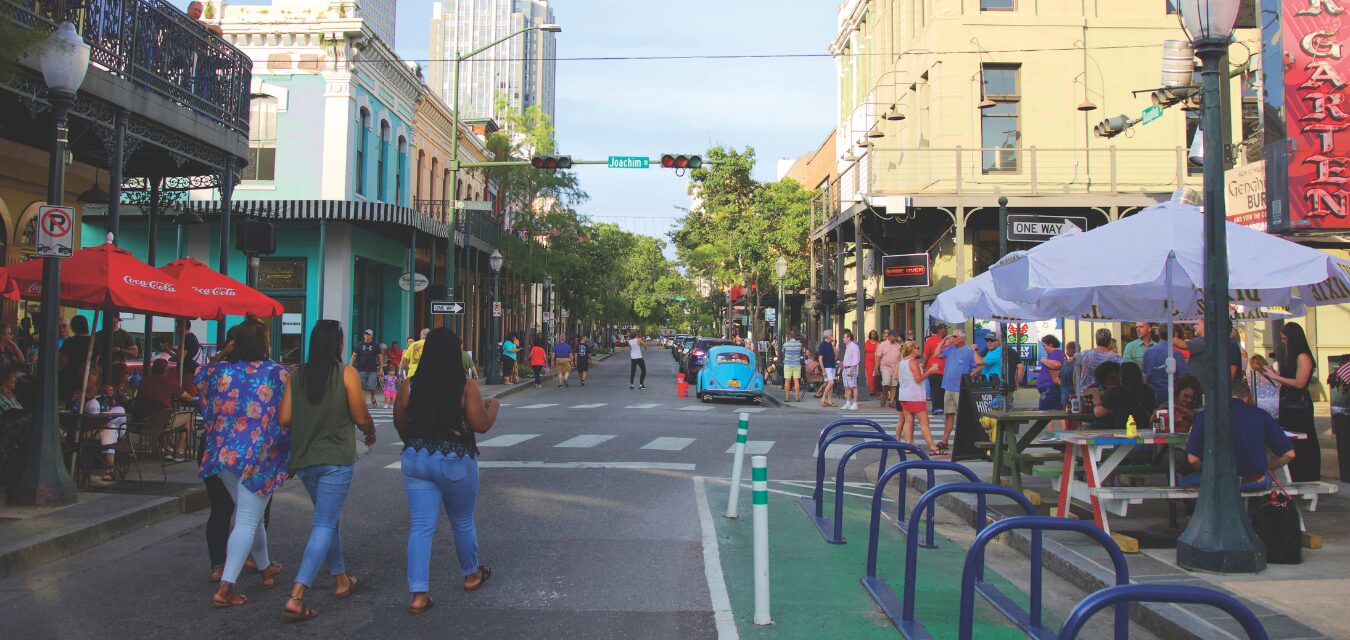 Three women walking down a main street in Mobile, Alabama.