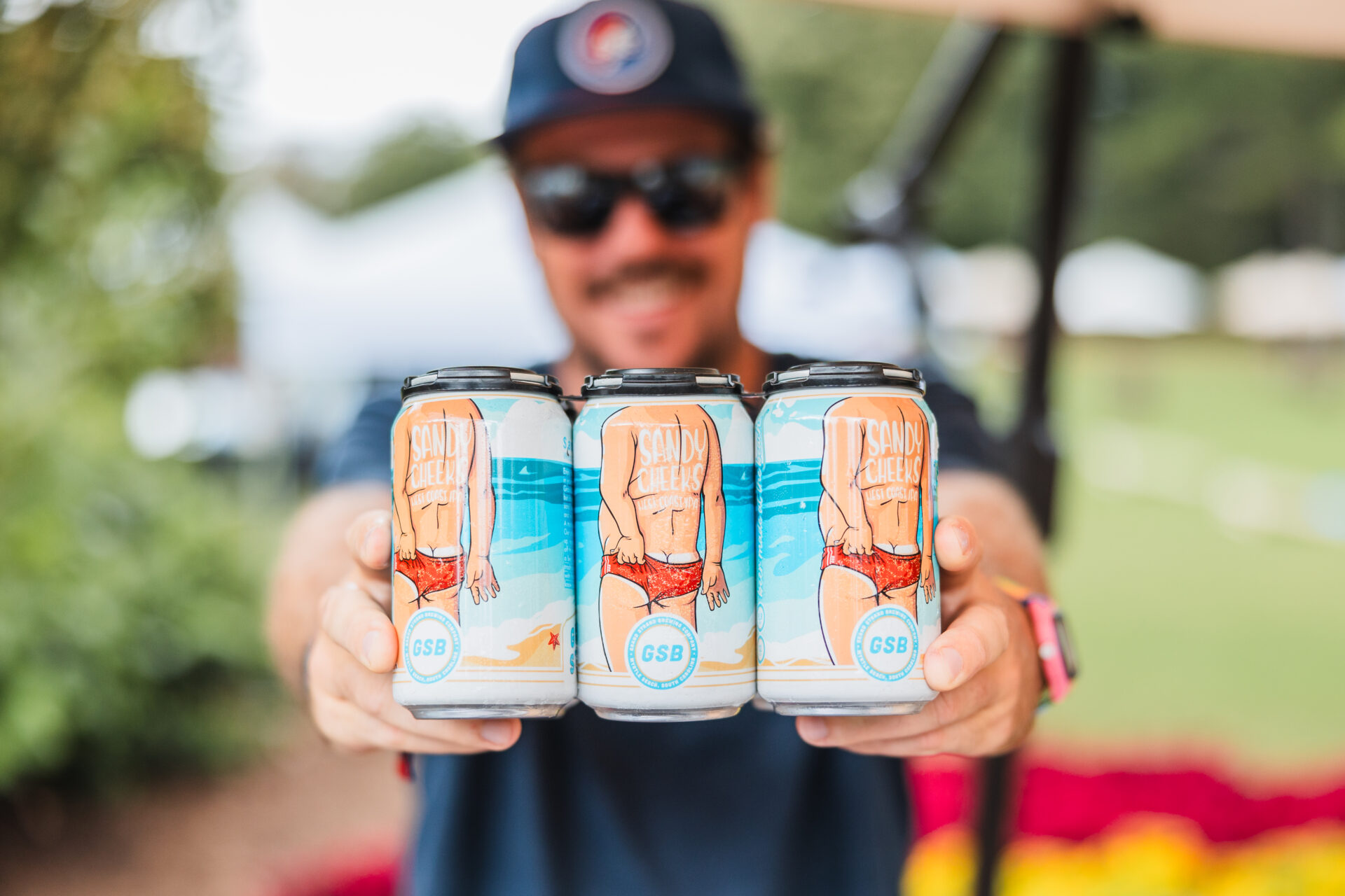 A man hands out beers at the MFGB Beer Fest