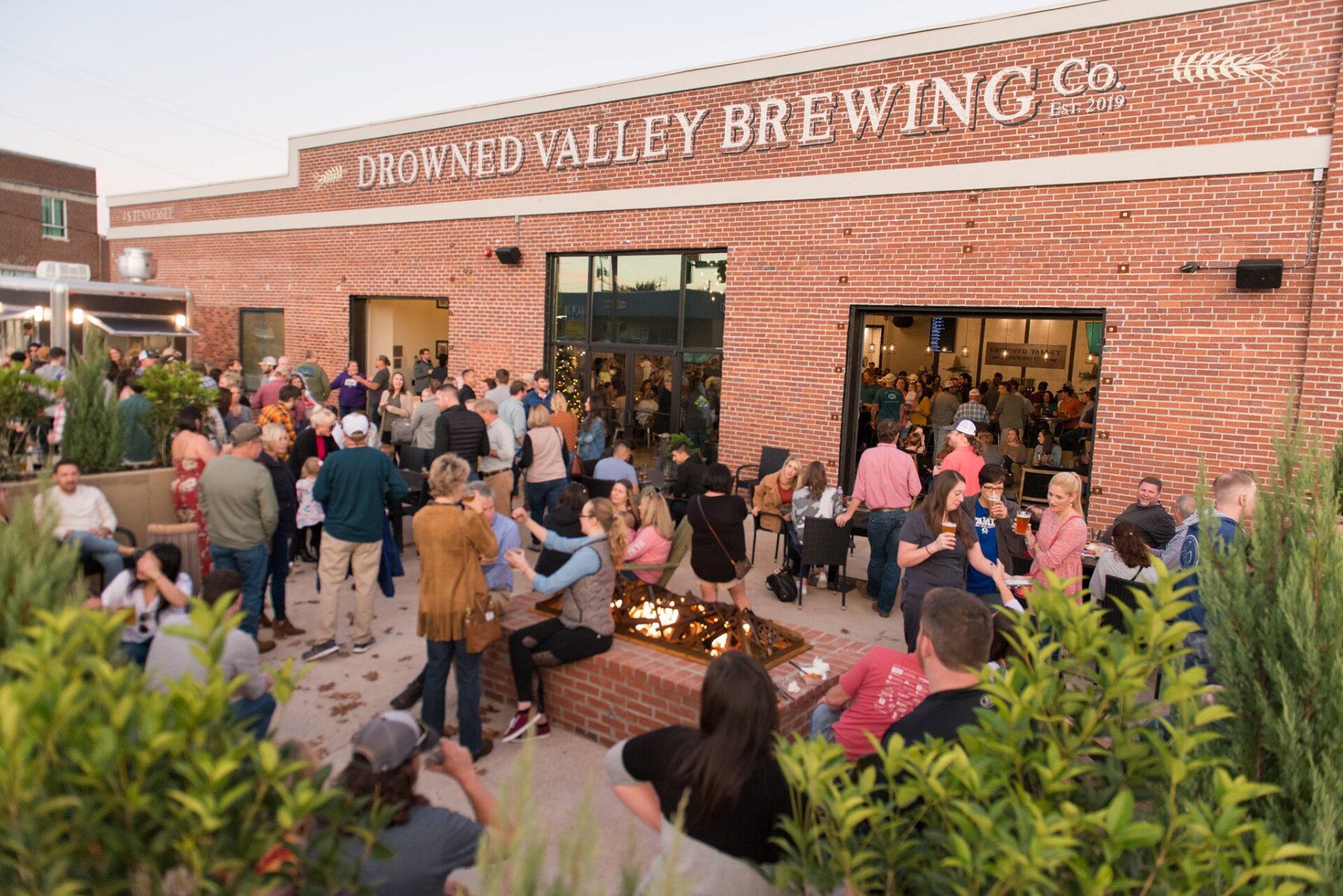 A small but close-knit crowd gathers among the fire pit at Drowned Valley Brewing Co.'s popular outdoor patio in Cartersville, Georgia.