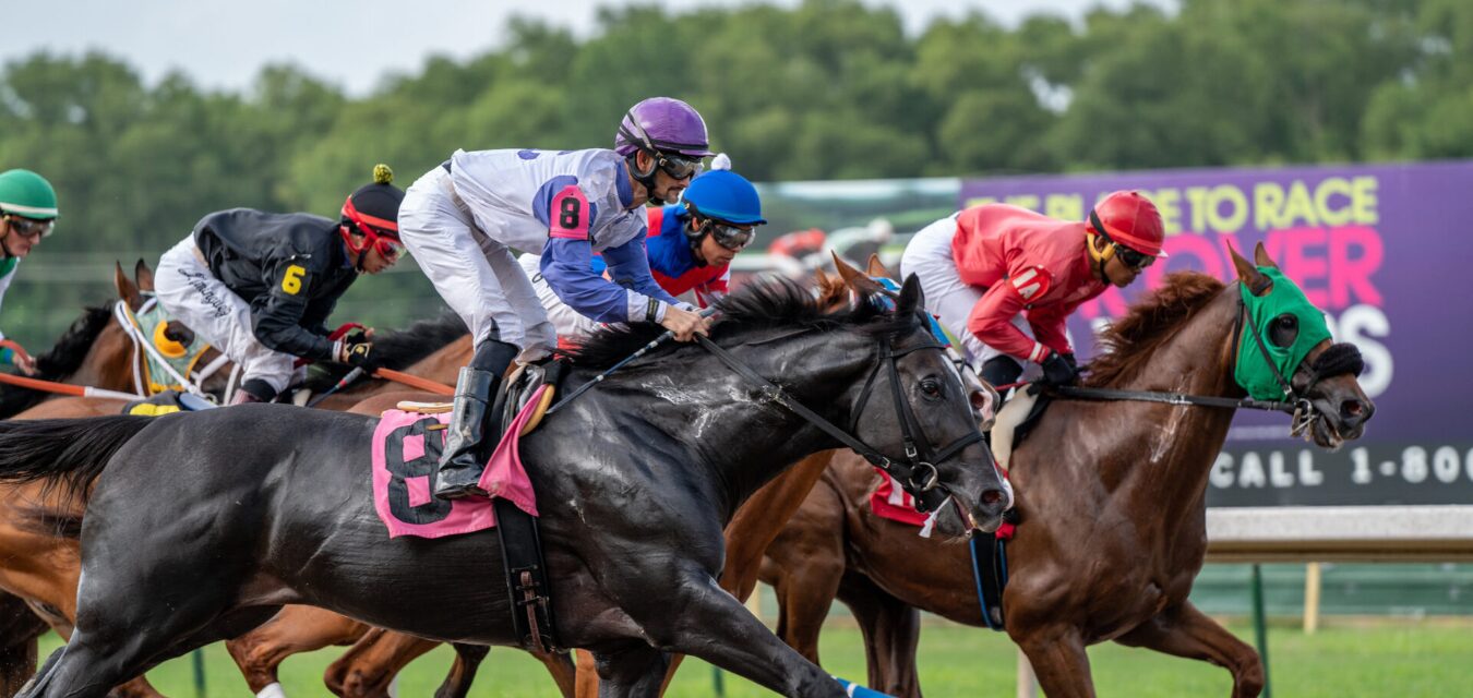 Jockeys racing horses at the Louisiana Downs, located in Shreveport-Bossier, Louisiana.