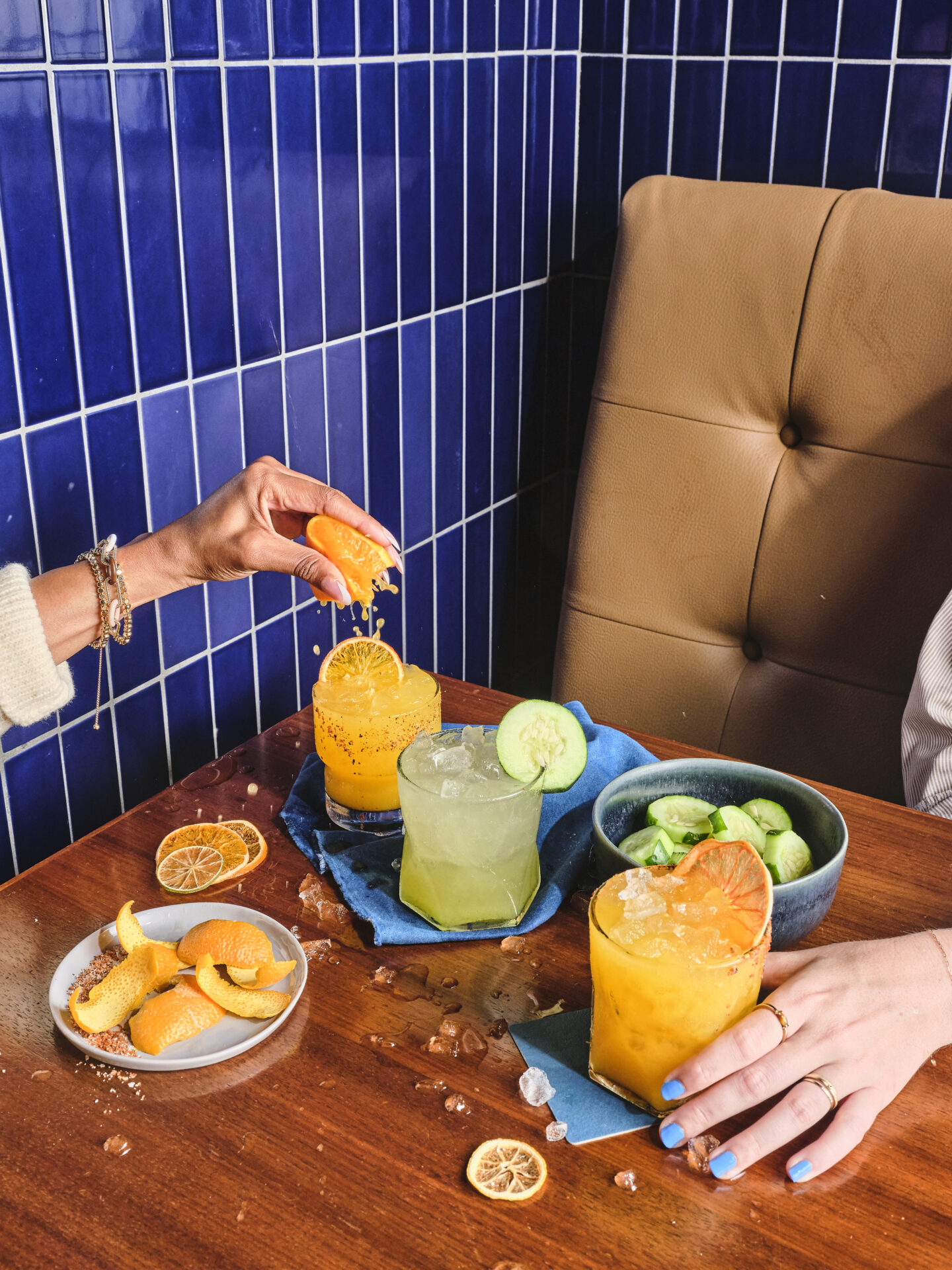 An array of cocktails being made with fresh squeezed citrus juice at Jobos cocktails