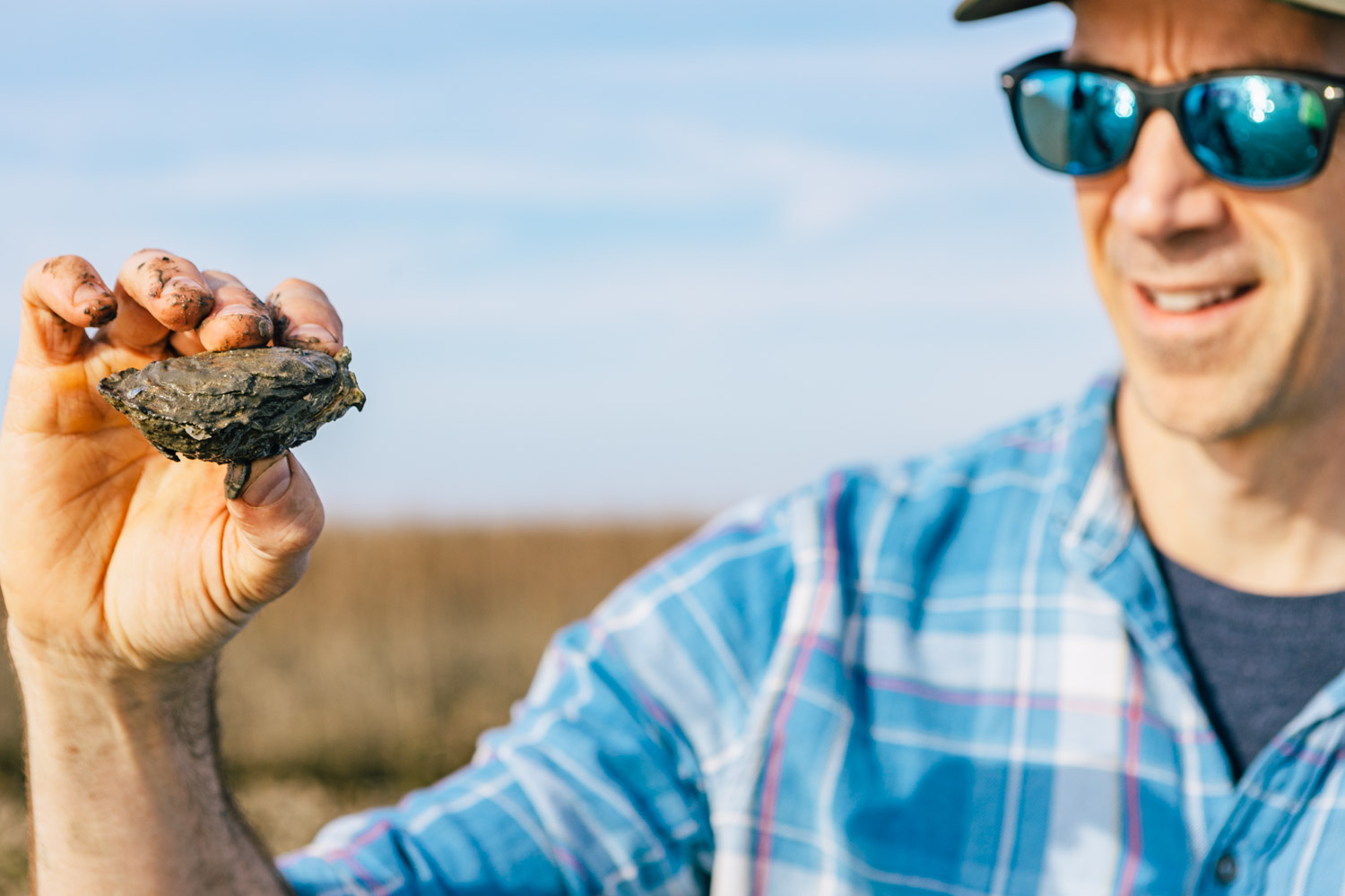 North Carolina oyster and seafood chef Dean Neff with oyster, by Baxter Miller