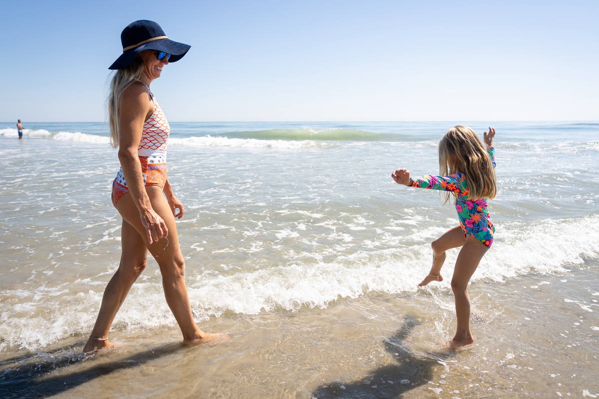 A women and a child playing in the surf at a beach in the Northern Outer Banks. 