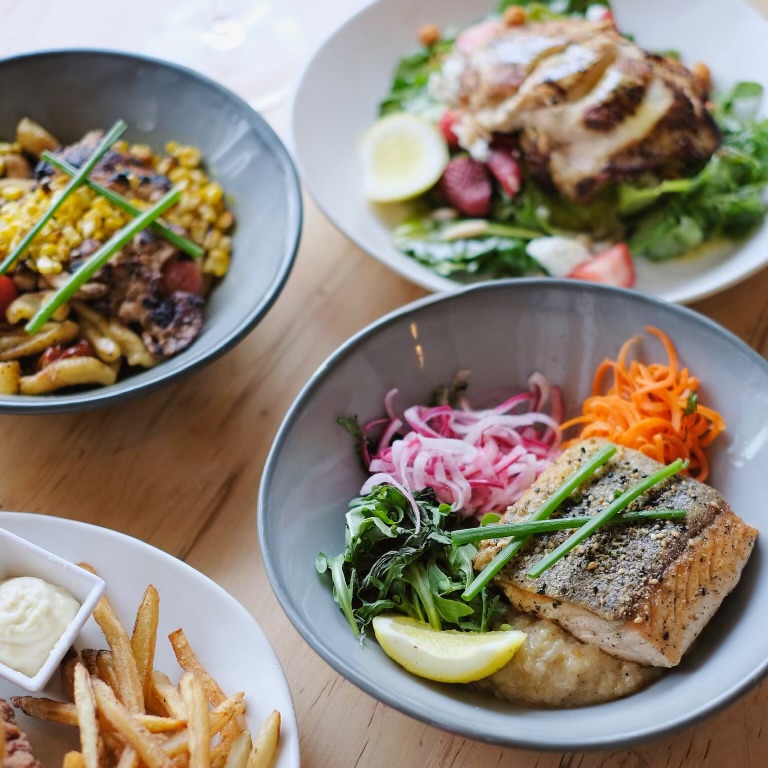 Bowls of impossibly fresh  fish, rice, carrots, red onions, and greens are ready to be eaten in Greensboro, North Carolina.  