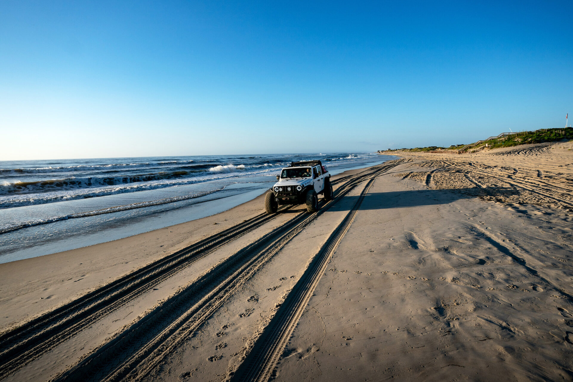 jeep driving on outer bank dunes